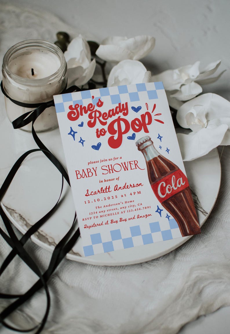 Puede incluir: Invitaci&oacute;n a un baby shower con el texto "She's Ready to Pop" en rojo y azul. La invitaci&oacute;n presenta una ilustraci&oacute;n de una botella de cola y detalles del evento, incluyendo la fecha, hora y lugar.