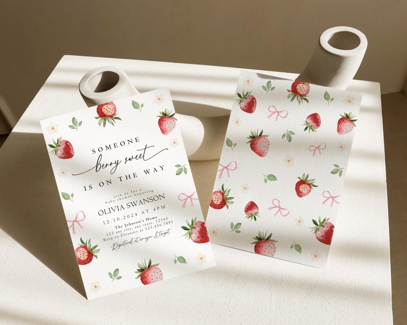 May include: A baby shower invitation with a strawberry theme. The invitation is white with pink and green accents. The text on the invitation reads "Someone berry sweet is on the way." The invitation also includes the name Olivia Swanson, the date 12.10.2024, and the time 4PM. The invitation is decorated with strawberries and bows.