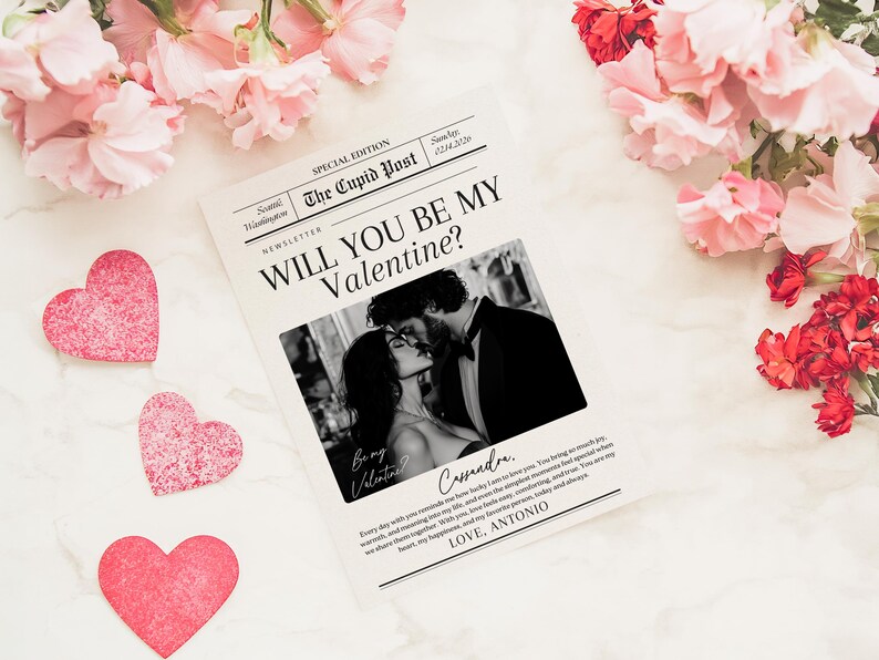 May include: A Valentine's Day themed image featuring a newspaper-style print with the headline "WILL YOU BE MY Valentine?" and a black and white photo of a couple kissing. Pink heart cutouts and flowers surround the print.