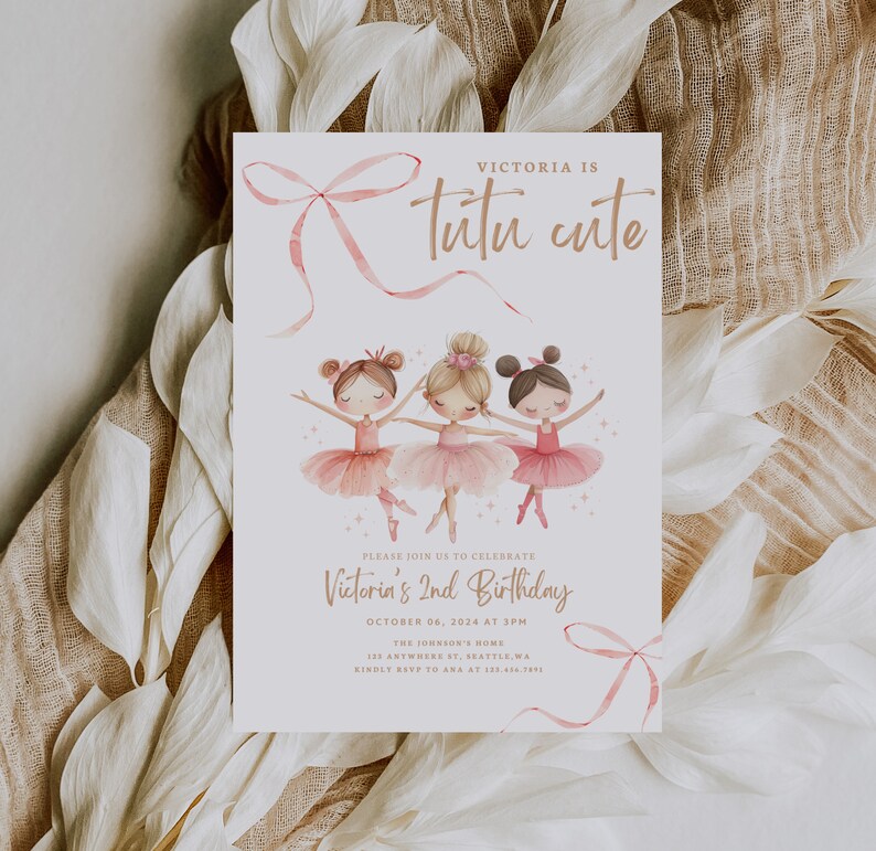 May include: A pink and white invitation card with a pink ribbon bow and three ballerina girls in pink tutus. The text on the card reads "Victoria is Tutu Cute" and "Victoria's 2nd Birthday".