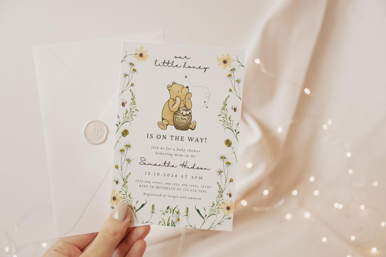 May include: Baby shower invitation featuring a Winnie the Pooh illustration with the text "our little honey is on the way!". The invitation is decorated with floral elements and includes event details. An envelope with a wax seal is also present.