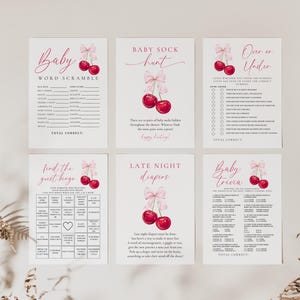 May include: Set of six printable baby shower game cards featuring a cherry motif. The games include Baby Word Scramble, Baby Sock Hunt, Over or Under, Find the Guest Bingo, Late Night Diapers, and Baby Trivia.