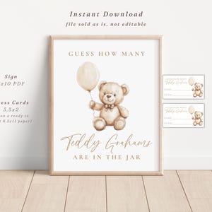 May include: A framed sign and guess cards for a baby shower. The sign reads "Guess How Many Teddy Grahams Are In The Jar" with a watercolor teddy bear holding a balloon. The sign is 8x10 inches.