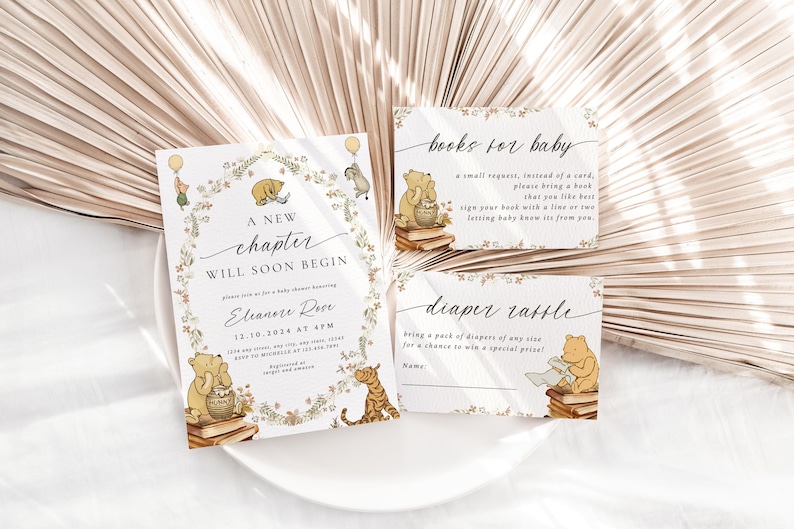 May include: A Winnie the Pooh themed baby shower invitation with a floral wreath border. The invitation reads "A new chapter will soon begin" and includes the date and time of the shower. There are two cards for guests to fill out, one for a diaper raffle and one for a book request.