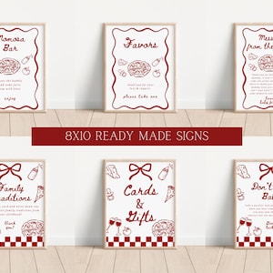 K&ouml;nnte beinhalten: Sechs gerahmte Schilder mit roten und wei&szlig;en Illustrationen und Text. Die Schilder sind f&uuml;r eine Babyparty gedacht und enthalten S&auml;tze wie "Momosa Bar", "Favors" und "Cards & Gifts". Die Schilder sind 20 x 25 cm gro&szlig;.