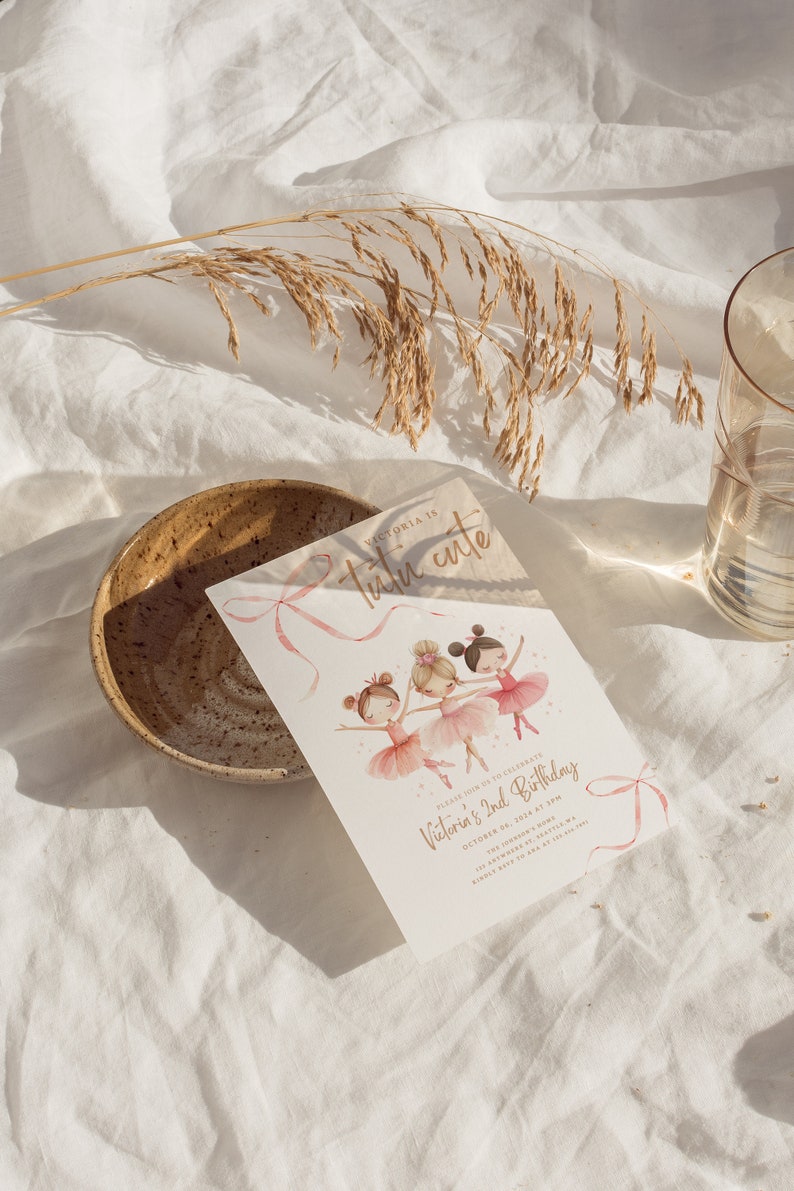 May include: A pink and gold invitation card with a watercolor illustration of three ballerinas. The text on the card reads "Victoria is Tutu Cute" and "Please join us to celebrate Victoria's 2nd Birthday, October 04, 2024 at 3PM."