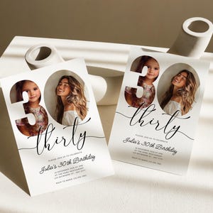 May include: White invitation card with a black and white photo of two people in a 30 cutout. The text "thirty" is written in a cursive font. The invitation reads "Please join us to celebrate Julia's 30th Birthday".