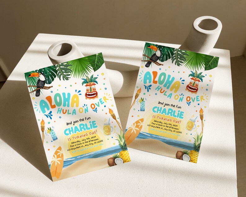 May include: Two colorful invitations for a luau themed birthday party. The invitations feature a toucan, a tiki mask, and the text "Aloha Hula On Over" and "Charlie is turning one!"