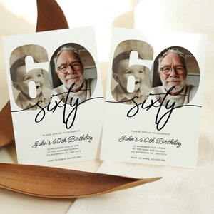 May include: A white invitation card with a black and white photo of a man and a young boy. The number 60 is in the background with the word "sixty" written in cursive. The text on the card reads "Please join us to celebrate John's 60th Birthday" with the date, time, location, and RSVP information.