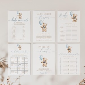 May include: A set of six baby shower game cards featuring a cute teddy bear holding a blue balloon. The games include "Baby Animals", "Late Night Diapers", "Baby Alphabetize", "Find the Good Bingo", "Pacifier Hunt", and "What's in the Baby's Diaper".