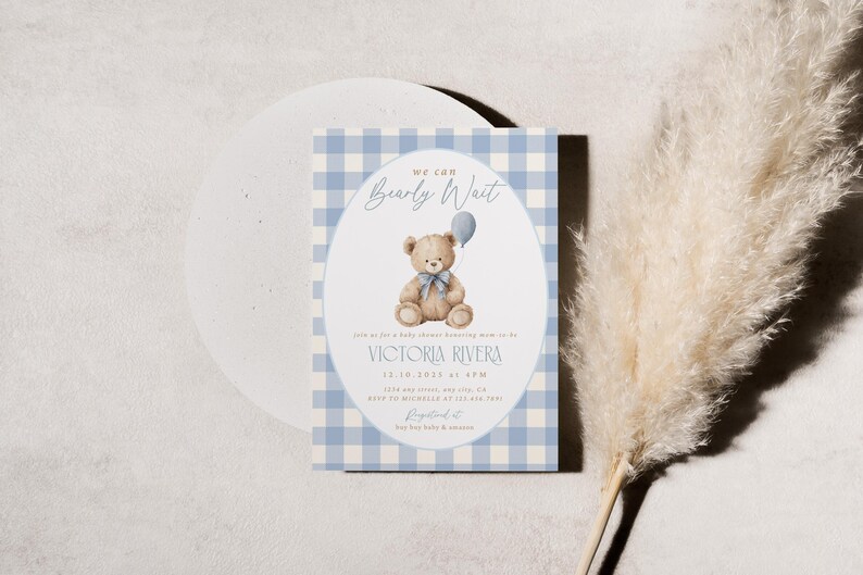 May include: Baby shower invitation with a blue gingham pattern background. The invitation features a watercolor illustration of a teddy bear holding a balloon. The text reads "We can bearly wait" and includes event details.