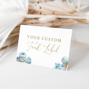 May include: A white card with gold text that reads "Your Custom Food Label". The card is decorated with blue and white watercolour illustrations of doughnuts, cupcakes, and ice cream.