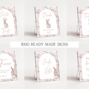 May include: Set of ten 8x10 inch printable signs featuring a pink floral design with a bunny rabbit illustration. The signs include the text: "Sweets & Treats", "Drinks", "Guest Book", "Favors", "Cards & Gifts", and "Photo Guestbook".
