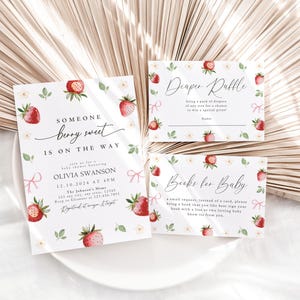 May include: A set of three baby shower cards with a strawberry theme. The invitation card says "Someone berry sweet is on the way." The diaper raffle card says "Diaper Raffle" and the book request card says "Books for Baby".