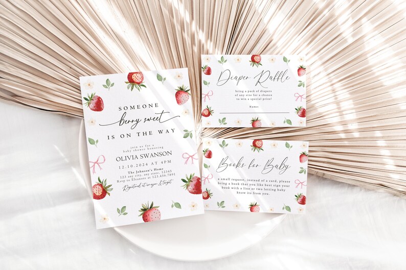 May include: A set of three baby shower cards with a strawberry theme. The invitation card says "Someone berry sweet is on the way." The diaper raffle card says "Diaper Raffle" and the book request card says "Books for Baby".