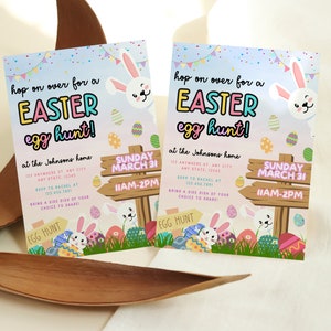 May include: A colorful Easter egg hunt invitation with a bunny rabbit, eggs, and a sign that says "Sunday March 31 11AM-2PM". The invitation says "Hop on over for an Easter egg hunt! at the Johnsons home 123 Anywhere St. Any City Any State 12345 RSVP to Rachel at 123 456 7891 Bring a side dish of your choice to share!"