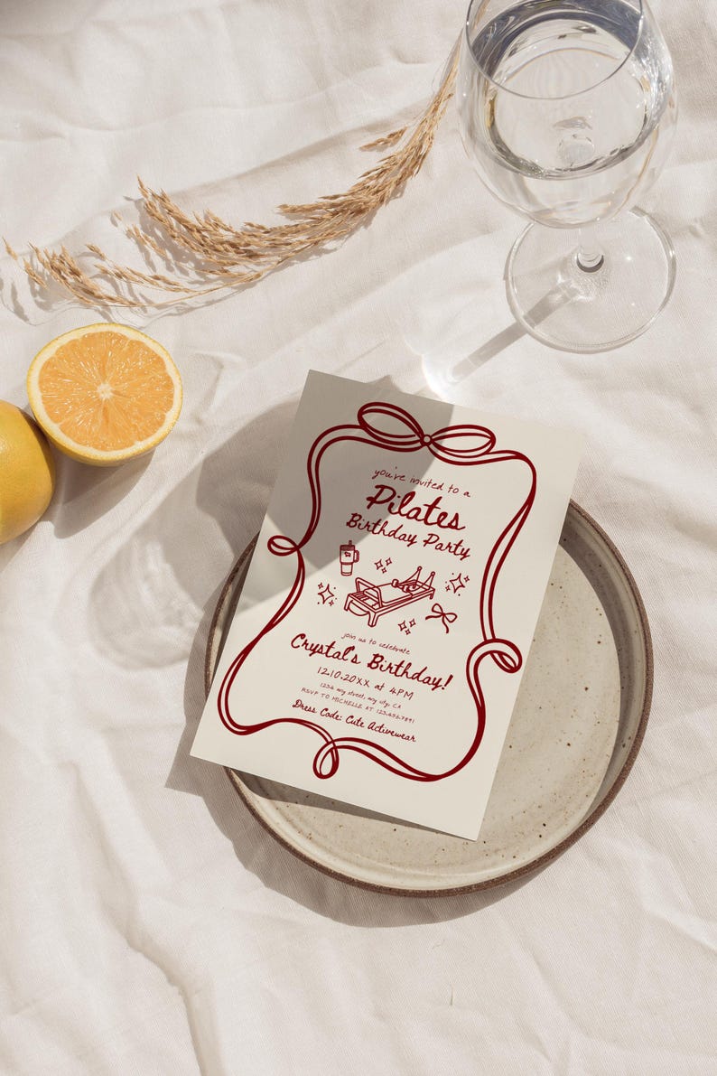 May include: A Pilates birthday party invitation with a red border and text. The invitation includes the text "Pilates Birthday Party" and "Crystal's Birthday!" along with event details. A glass of water and a lemon are also in the image.