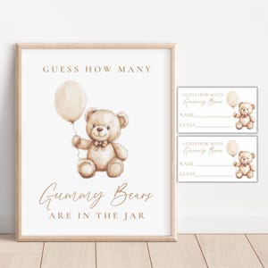 May include: A framed print with a watercolor illustration of a teddy bear holding a balloon. The text reads "Guess How Many Gummy Bears Are In The Jar." Two matching guess cards are also visible.