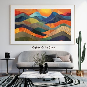 May include: Abstract art print of a colourful landscape with a sunset over a mountain range. The print is framed and hanging on a white wall above a sofa and coffee table.