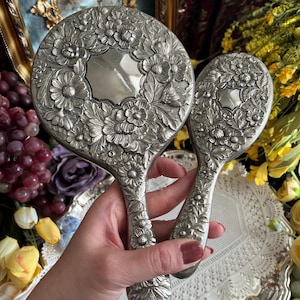 May include: A set of three ceramic mugs with a speckled, matte finish. The mugs are in shades of cream, light gray, and dark gray. Each mug has a simple, minimalist design, perfect for coffee or tea.