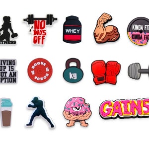 May include: A set of 12 colorful shoe charms with fitness and workout themes. The charms feature images of dumbbells, a protein shaker, a donut, boxing gloves, and more. The charms are made of rubber and have a glossy finish.