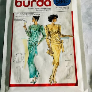 May include: A Burda sewing pattern packet, model 5848, featuring illustrations of two women's outfits. The packet includes text in German, French, and English, with size information. The outfits include a top, skirt, and jacket.