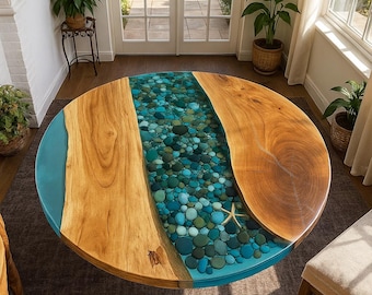 May include: A round wooden coffee table with a unique design. The table features a central river of blue and green stones encased in resin, flanked by two sections of natural wood. A starfish is embedded in the resin.
