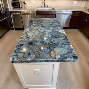 May include: A kitchen island countertop with a blue and white agate countertop. The countertop is made of natural stone and has a unique, swirling pattern.