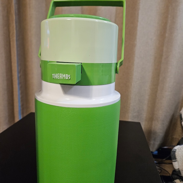 Vintage Thermos Compact Size "Jet Jug" circa 1970's. Has Pump Top, Holds 1/2 Gallon of Liquid and is Lightweight. Color is Green and White.