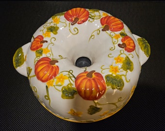 Vintage Ceramic Round Bundt Cake Pan. Has Handles on 2 Sides and Pumpkins, Vines and Flowers Decorating the Outside.