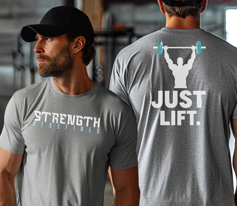 May include: Two gray t-shirts with white text. The shirt on the left says "STRENGTH REDEFINED". The shirt on the right says "JUST LIFT." with a silhouette of a person lifting a barbell.