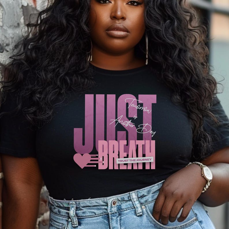 May include: Black t-shirt featuring the words "JUST BREATHE" in a purple gradient, with the phrase "Tomorrow is Another Day" and a heart graphic. The text "TRUST THE JOURNEY" is also included.