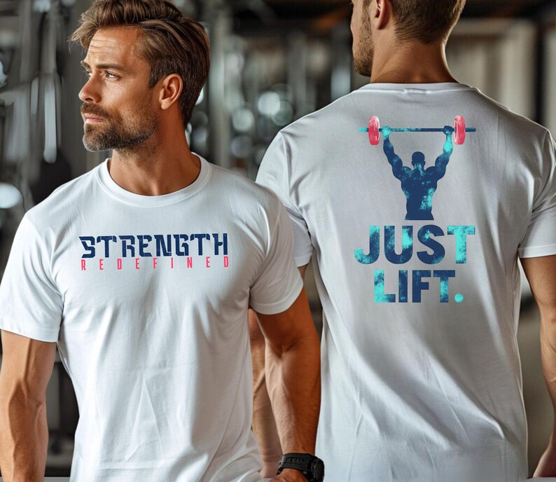May include: Two white t-shirts with a fitness theme. One shirt says "Strength Redefined" in blue and red lettering. The other shirt says "Just Lift" in blue and teal lettering with a silhouette of a weightlifter in the center.