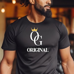 May include: Black t-shirt with a white "OG ORIGINAL" graphic and a gold crown above the letters.