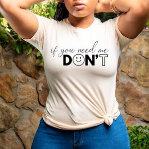以下が含まれることがあります： 白いTシャツに「if you need me DON'T」という黒い文字がプリントされています。「DON'T」の「O」の部分はスマイリーになっています。