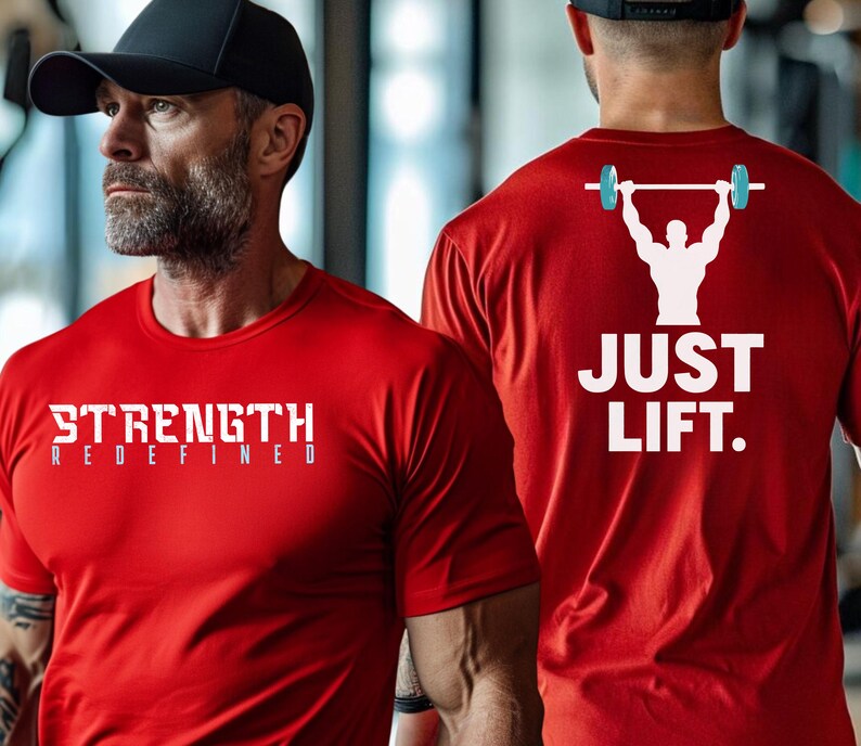 May include: Two red t-shirts with white text. One shirt says "STRENGTH REDEFINED" and the other says "JUST LIFT." with a graphic of a person lifting a barbell.