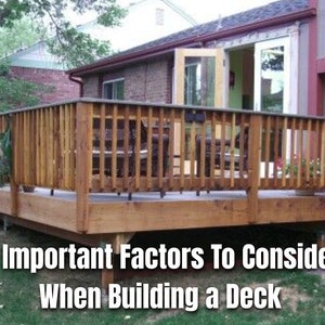 May include: A wooden deck with a railing, attached to a house with an open door. The deck is surrounded by green grass and trees. Text on the image reads: "12 Important Factors To Consider When Building a Deck."