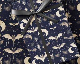 May include: A wrapped gift with a black ribbon sits on a matching patterned wrapping paper. The dark blue paper features a repeating pattern of bats, spiders, moons, and stars in a sepia tone, creating a spooky, Halloween theme.