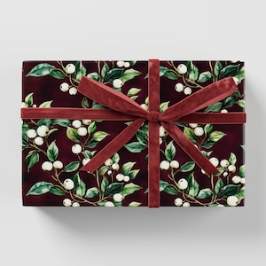 May include: A burgundy gift box with a white floral pattern and a red velvet ribbon.