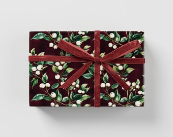 May include: A burgundy gift box with a white floral pattern and a red velvet ribbon.