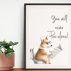 May include: Framed art print featuring a watercolor illustration of a corgi wearing glasses and reading a newspaper while sitting on a toilet. The text reads "You will never Pee alone!"