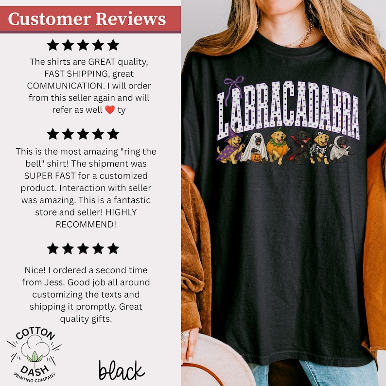 May include: A black t-shirt featuring the text LABRACADABRA in white polka-dot letters above a graphic of six Labrador dogs dressed in various Halloween costumes, including a witch, a ghost, a pumpkin, a vampire, a skeleton, and a mummy.