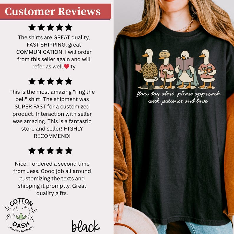 May include: Black t-shirt featuring a whimsical illustration of four ducks, each engaged in different activities. The ducks are depicted with various accessories and clothing. The text "flare day alert: please approach with patience and love" is printed below the ducks.