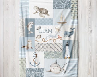 May include: A blue and white baby blanket with a patchwork design featuring sea creatures, a lighthouse, an anchor, and the names Liam James.
