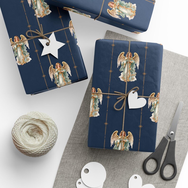 May include: Three gift boxes wrapped in blue wrapping paper with a gold pattern and images of angels. The boxes are tied with twine and have white gift tags attached.