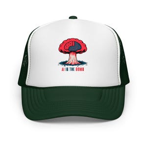 May include: A dark green and white trucker hat. The front panel is white, with a graphic of a red brain in the shape of a mushroom cloud. The text "AI IS THE BOMB" is printed below the graphic in red and white.