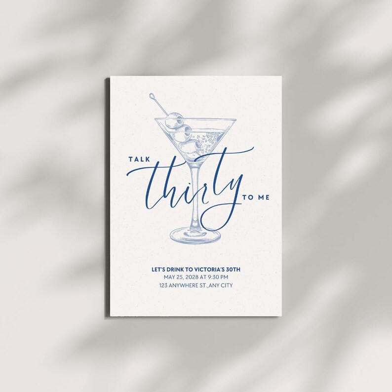 May include: A white invitation card with a blue illustration of a martini glass with olives. The text "Talk Thirty to Me" is written in a cursive font. Additional text includes event details.