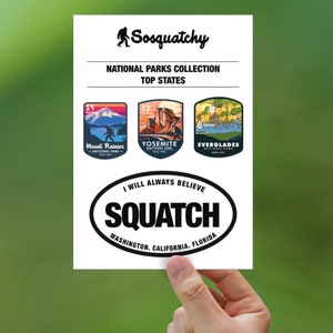 May include: A white sticker with a black oval containing the text "I will always believe SQUATCH Washington. California. Florida". Above the oval are three colorful national park stickers: Mount Rainier National Park, Yosemite National Park, and Everglades National Park.