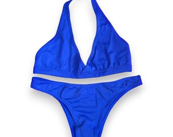 May include: A bright blue bikini with a halter top and a high-cut bottom.