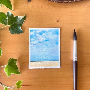 original mini watercolor painting about a lonely man on the beach